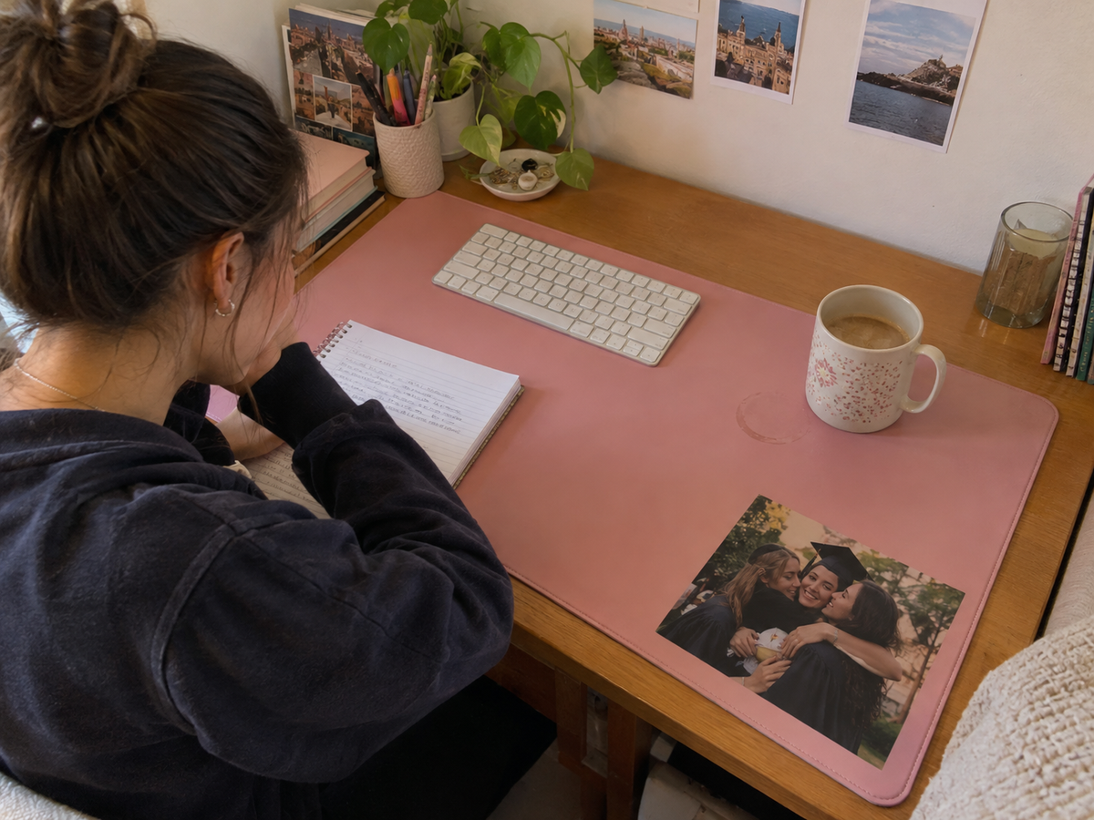 Pink desk mat printed with a graduation hug