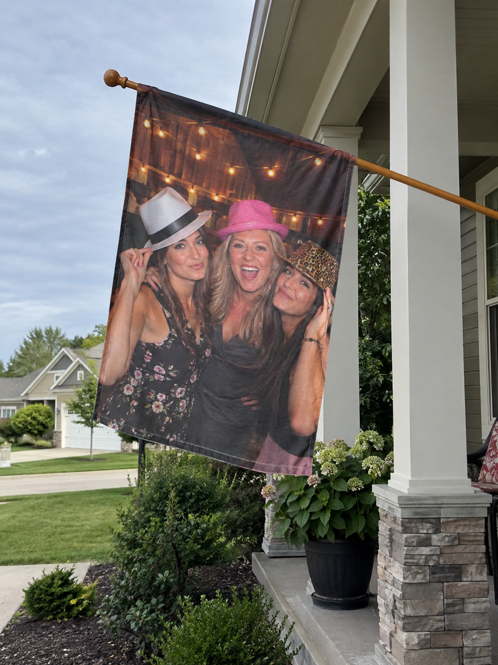 Porch flag printed with a photo of three friends in hats
