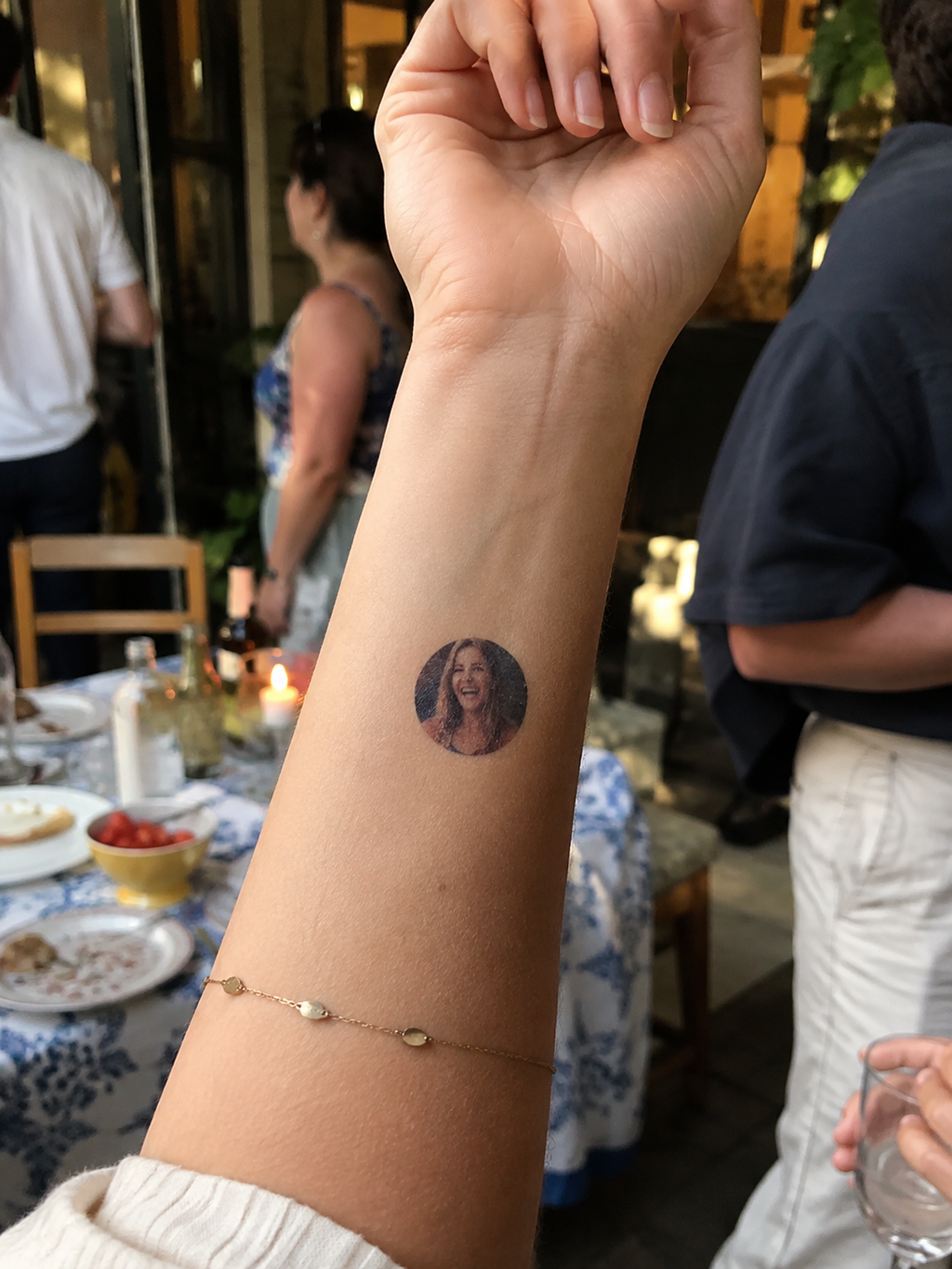 Small temporary personal photo tattoo on forearm