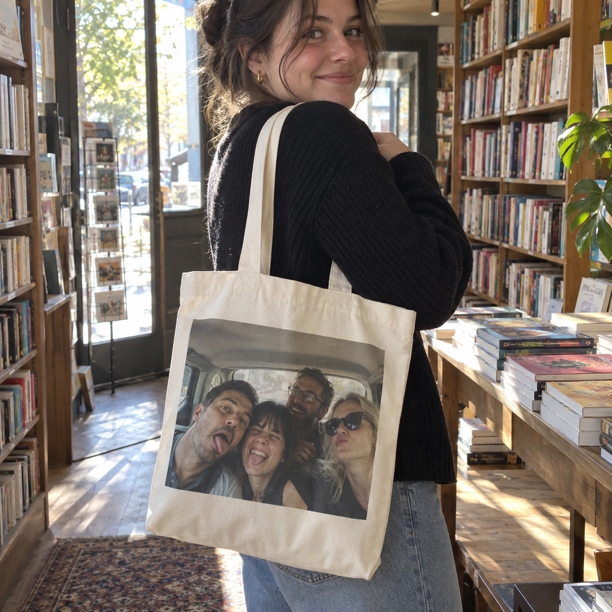 A canvas tote bag printed with a funny old group taxi selfie in a bookshop.