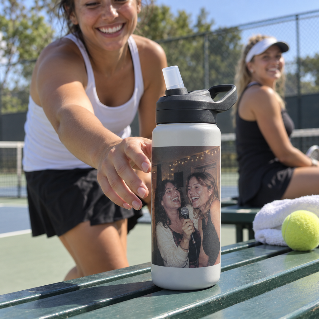 A sports bottle printed with an old karaoke photo on a tennis court bench.