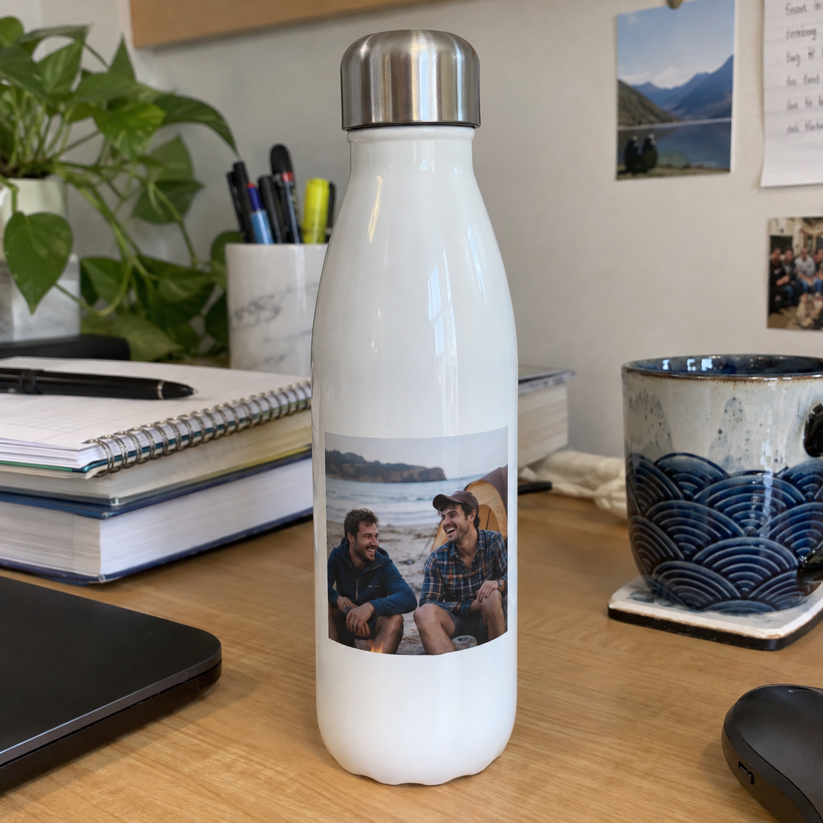 A slim water bottle printed with an old beach photo of two brothers.