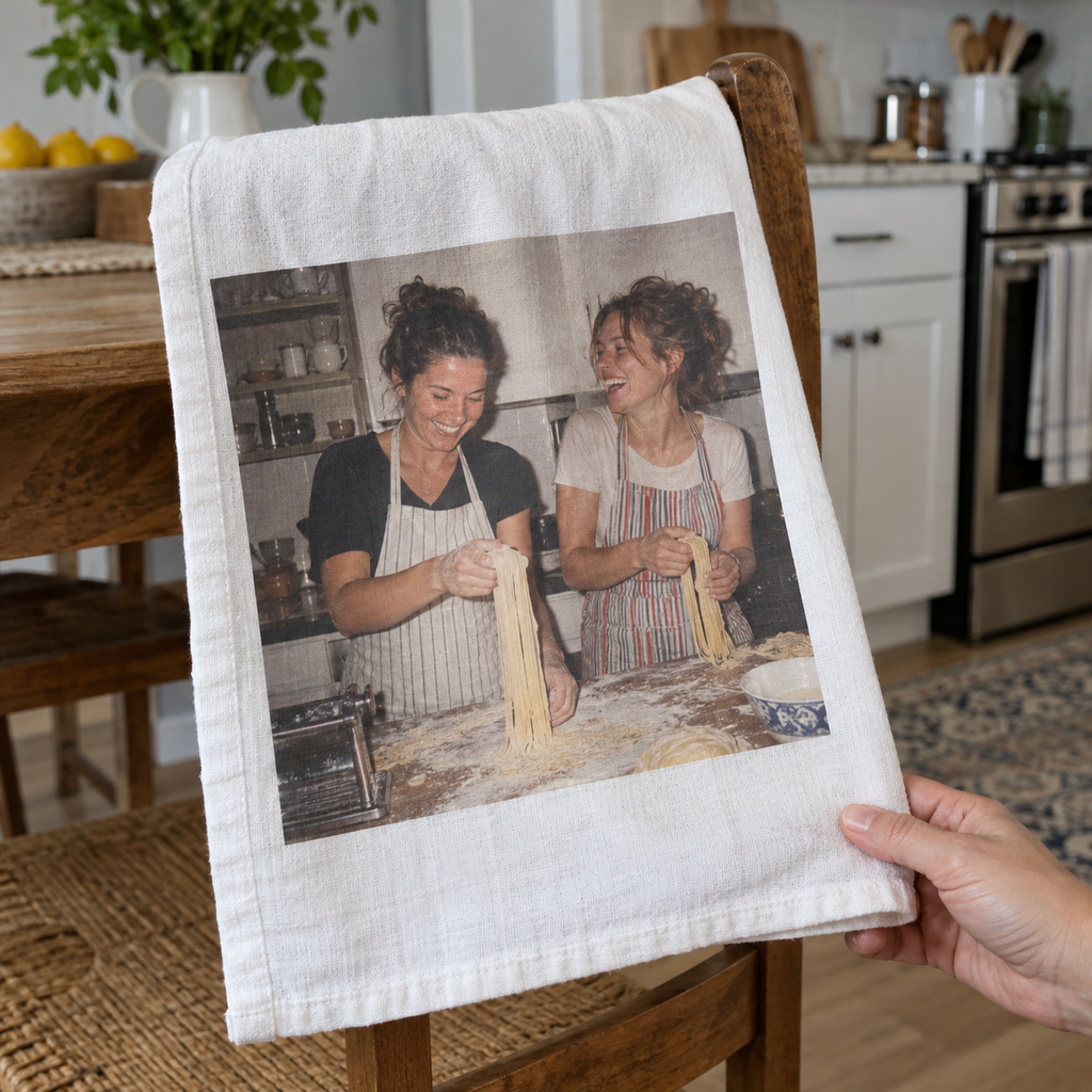 Tea towel printed with two friends making pasta together.