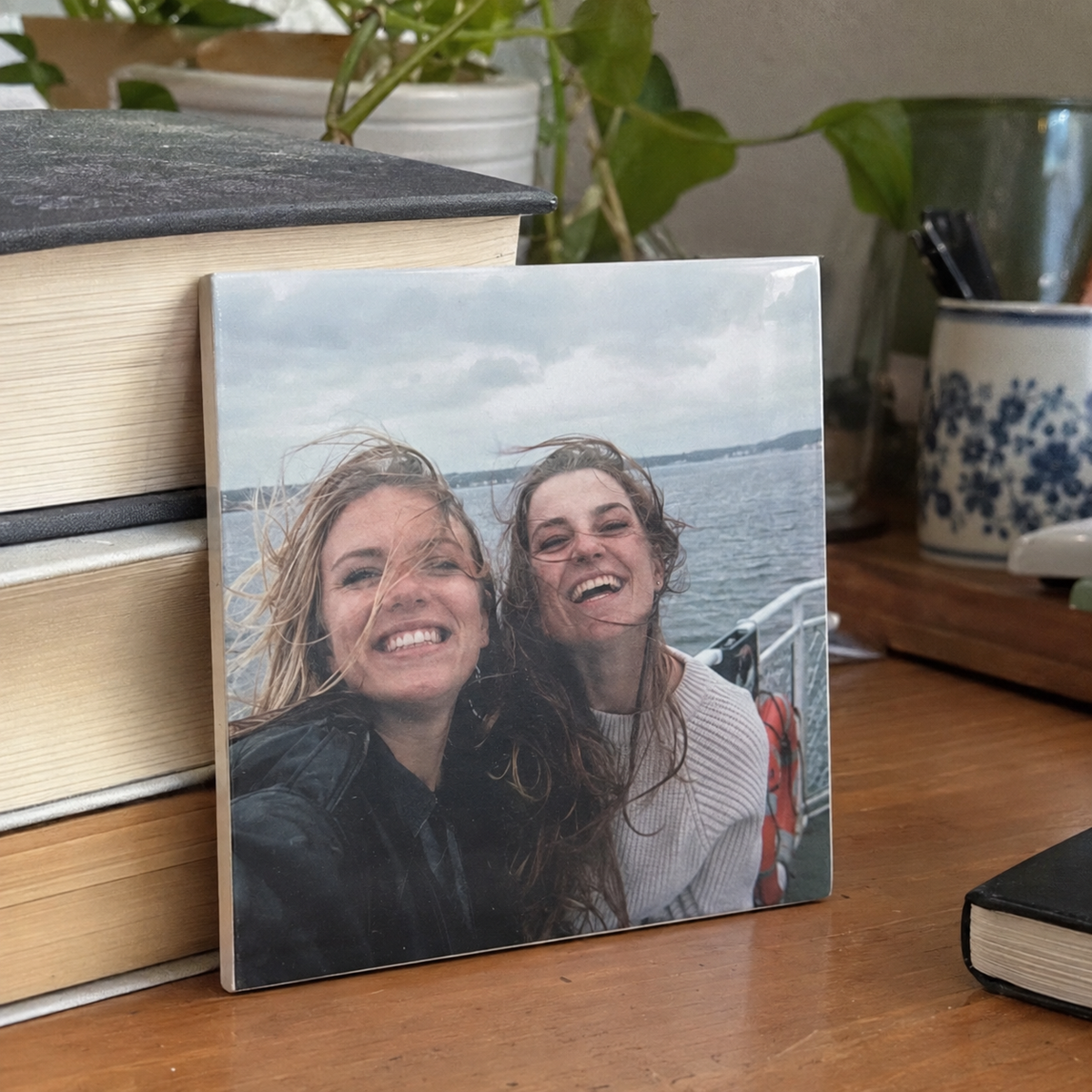 Ceramic tile printed with two friends on a ferry.