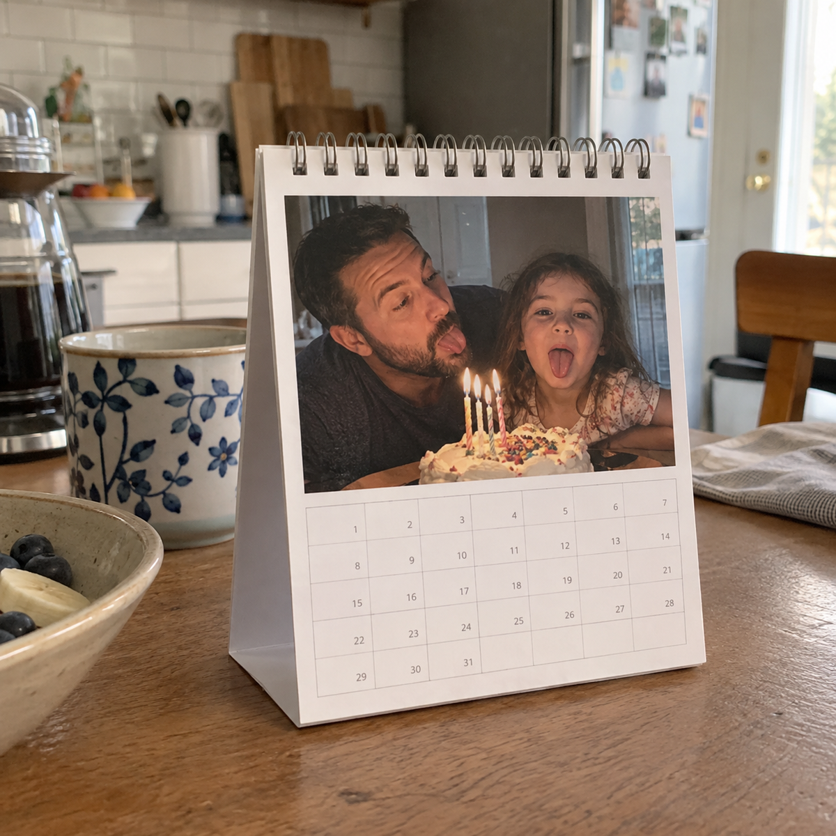 Desk photo calendar with a funny family birthday picture and date grid.
