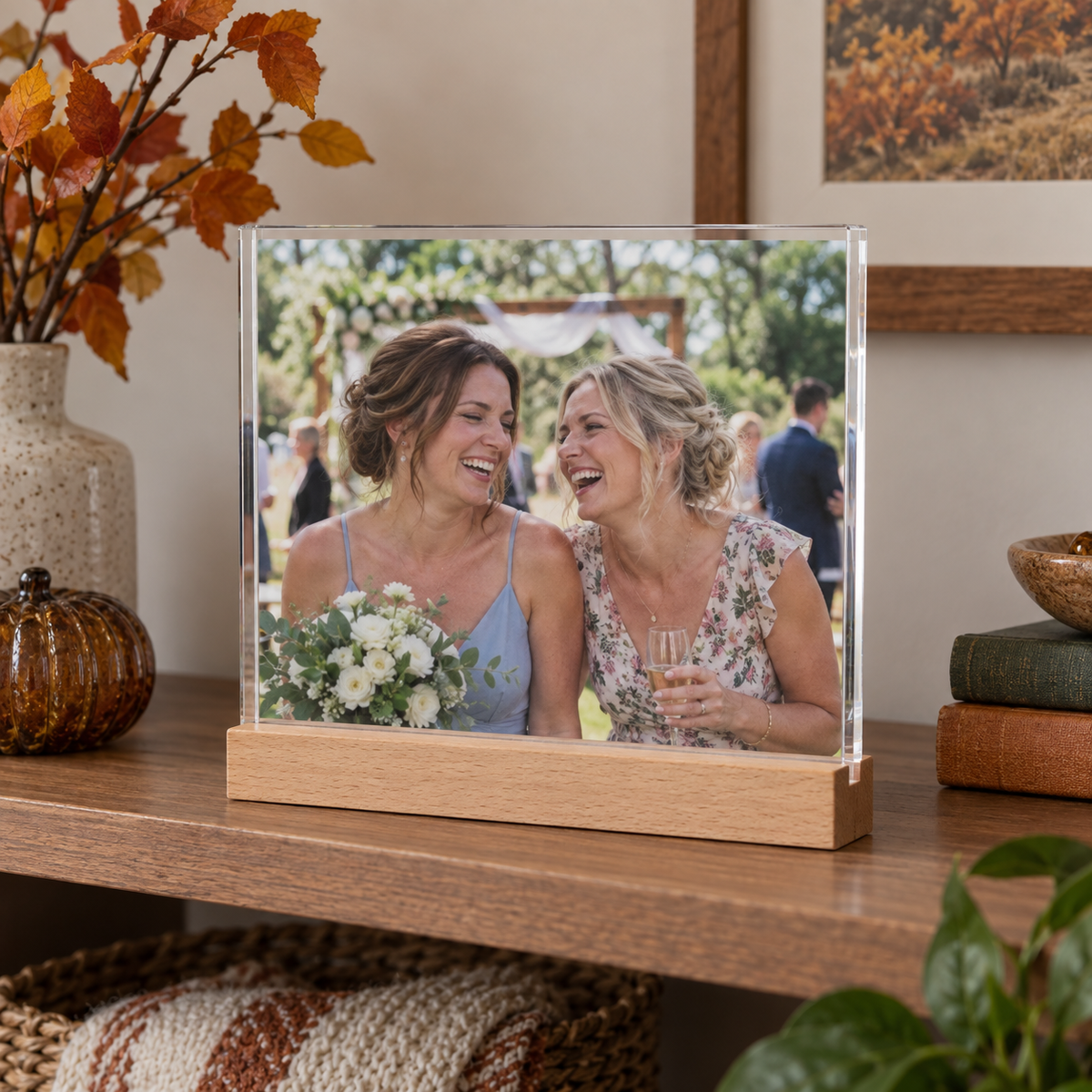 Acrylic photo sign with a wood stand showing two sisters at a wedding.