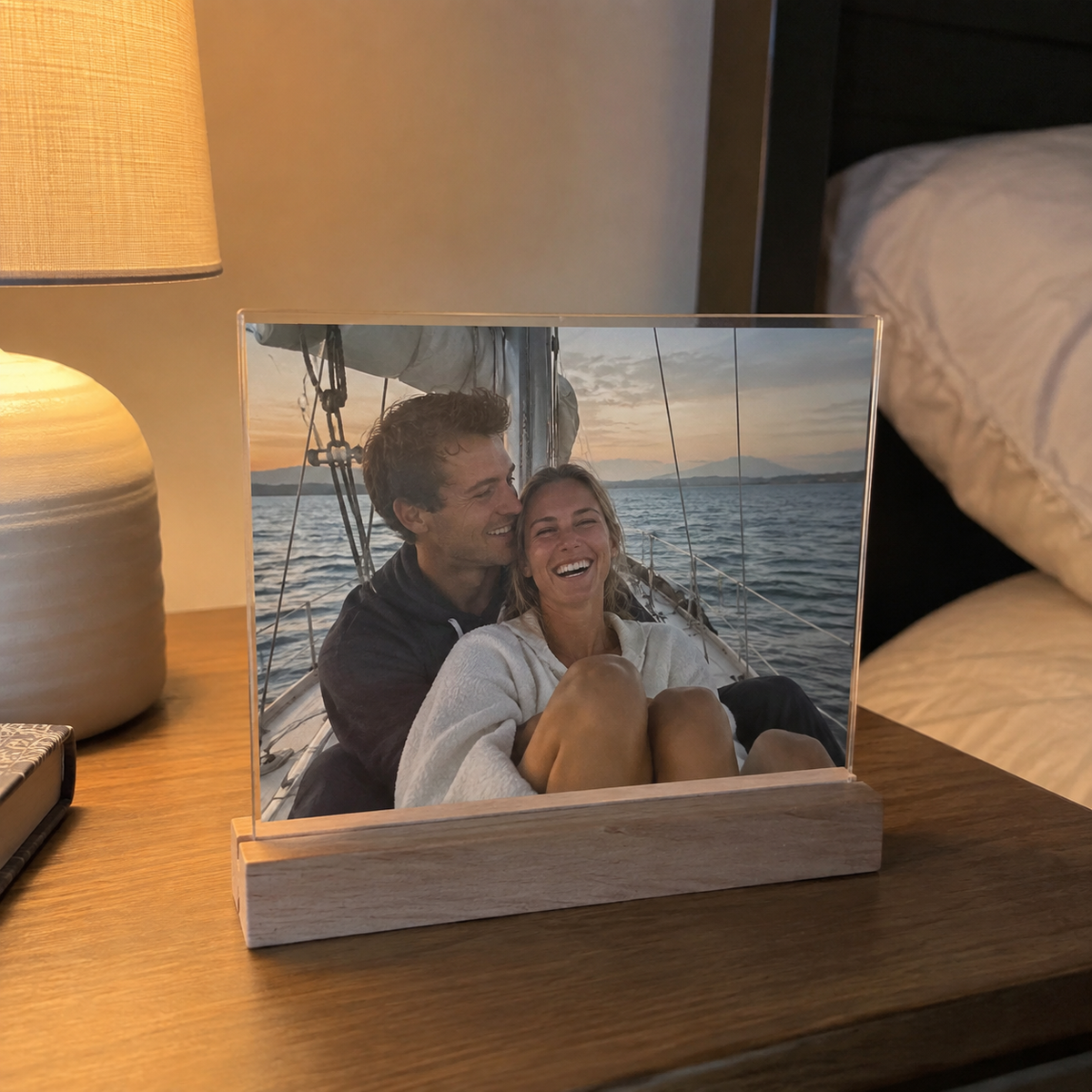 Acrylic photo sign in a wood stand with a couple sailing photo.
