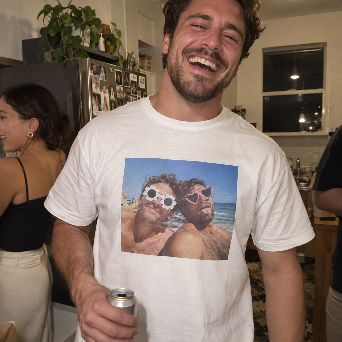 A white T-shirt printed with a funny beach photo of two friends at a house party.