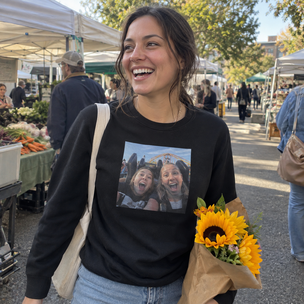 A black long-sleeve T-shirt printed with a rollercoaster selfie at a market.
