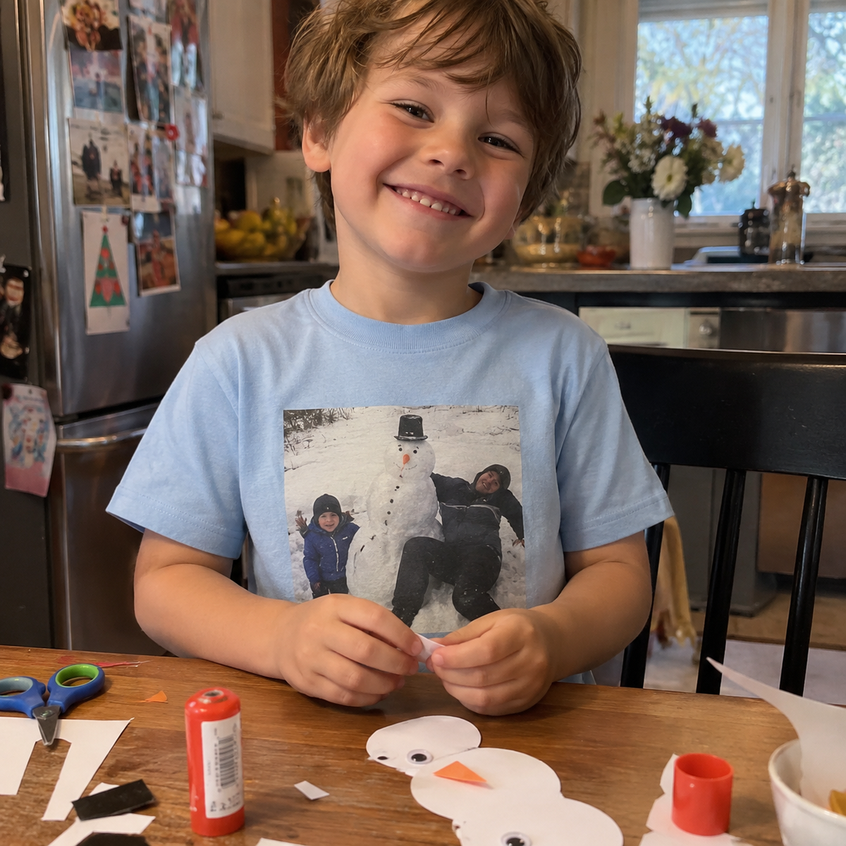 Kids blue T-shirt printed with a snowman family picture.