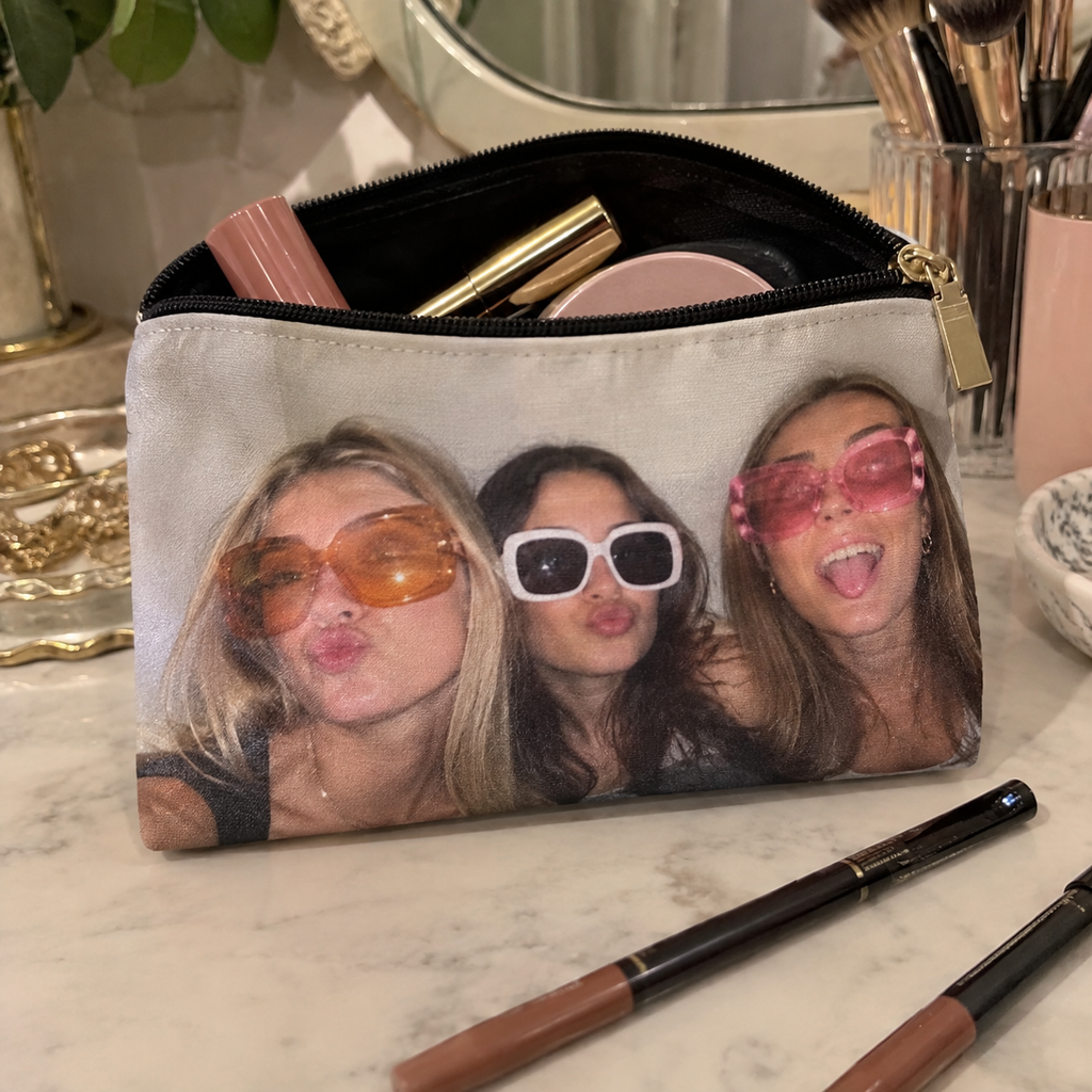 Essentials pouch printed with friends wearing oversized sunglasses.