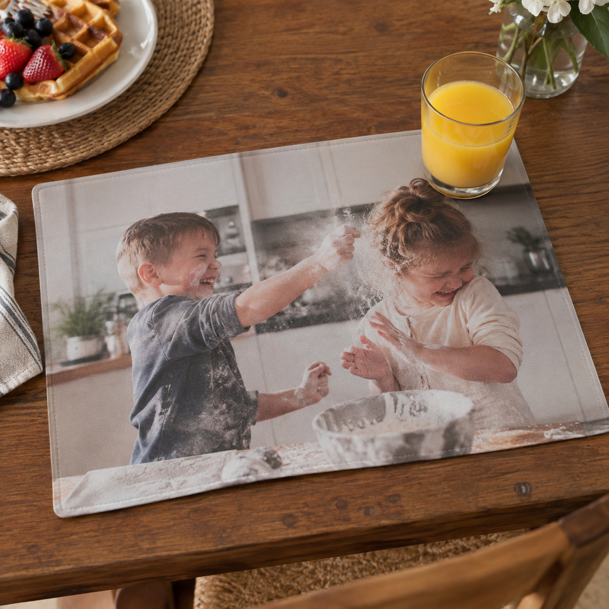 Photo placemat with siblings throwing flour during a baking session.