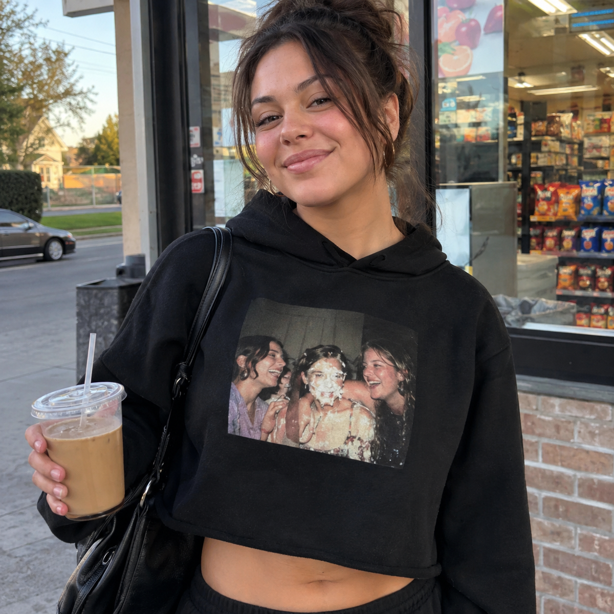 Cropped hoodie carrying a funny candid birthday cake photo.