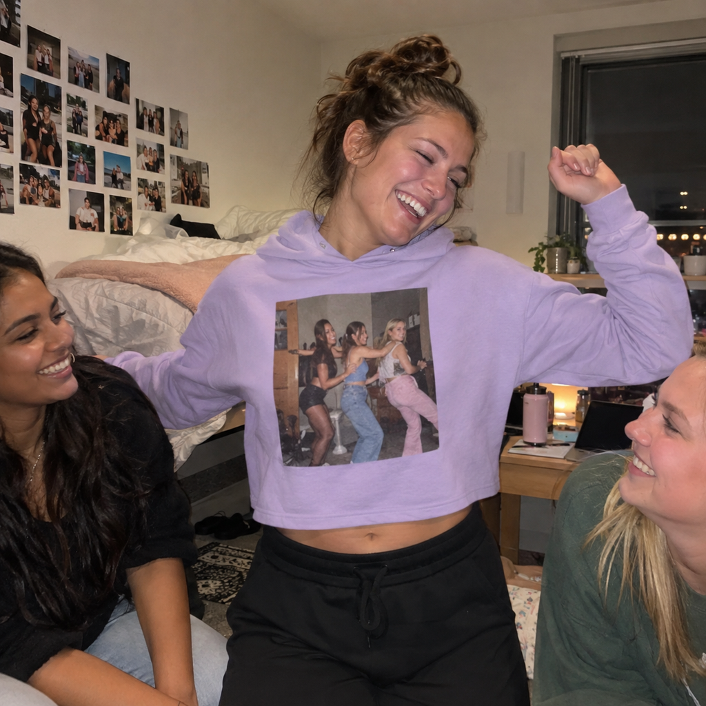 A lilac cropped hoodie printed with three dancing friends.