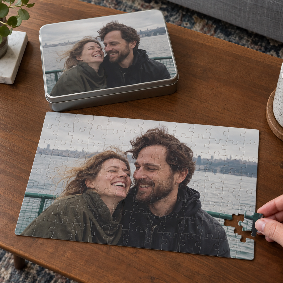 A photo puzzle and matching metal tin on a coffee table.