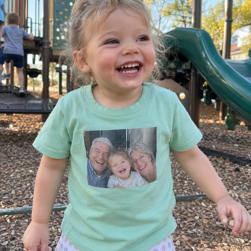 Mint toddler T-shirt printed with grandparents and child.
