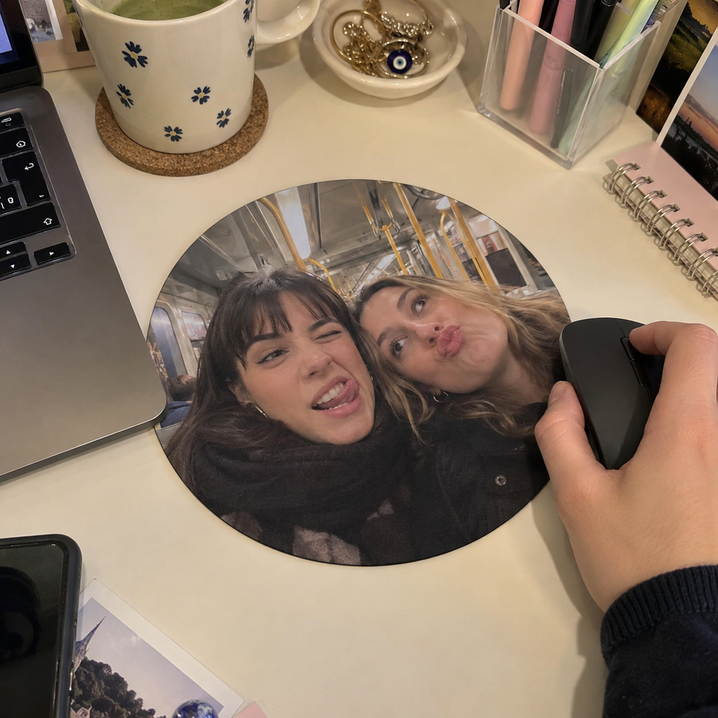 Round mouse pad with a friends' subway selfie.