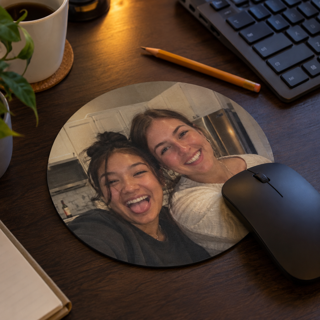 Round mouse pad with a candid family photo at a home desk.