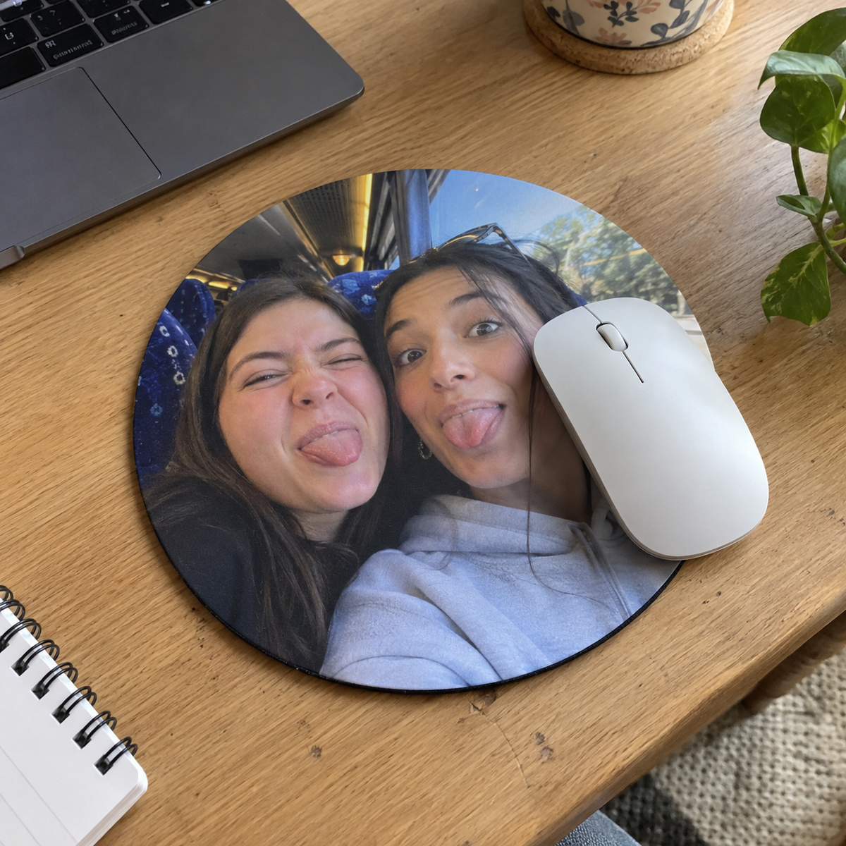 A round mouse pad printed with a funny sisters selfie.