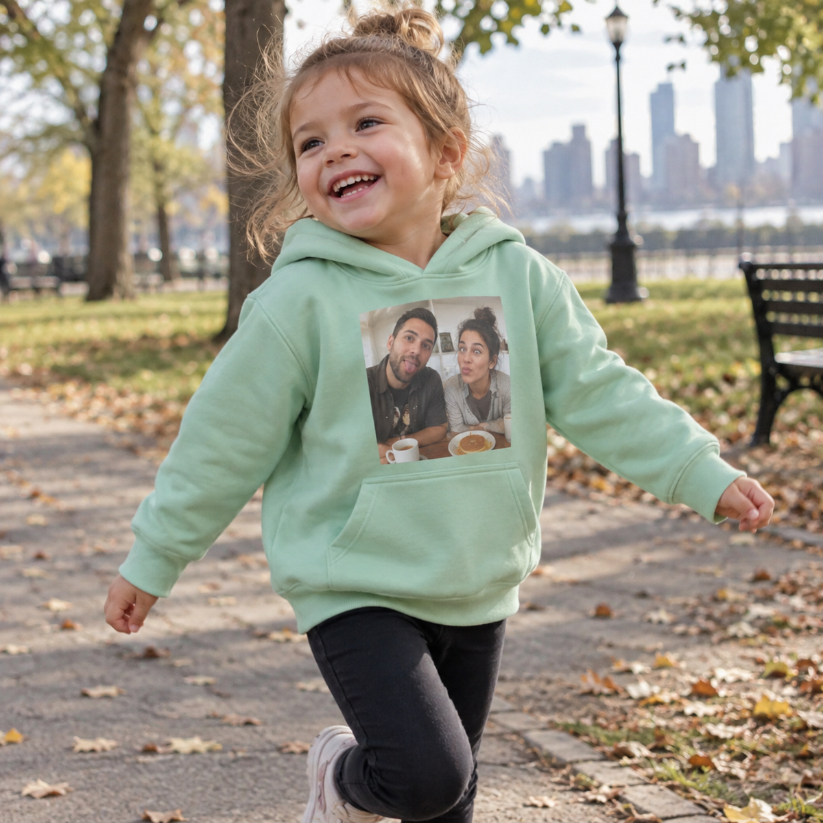 A toddler hoodie printed with a playful photograph of parents.