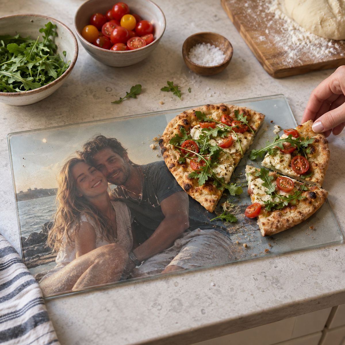 Glass cutting board with a seaside couple photograph beneath the glass.