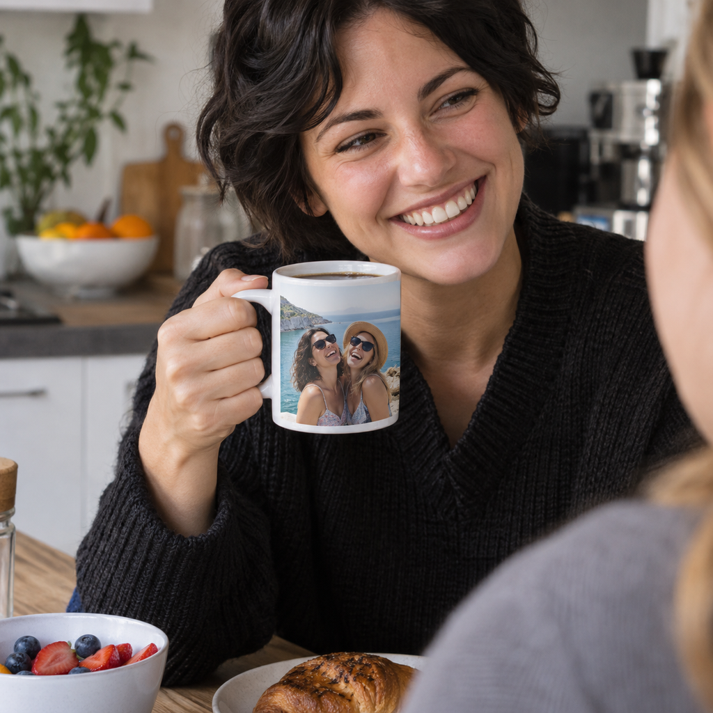 Personalized white ceramic mug printed with a seaside photo of two friends laughing over breakfast.
